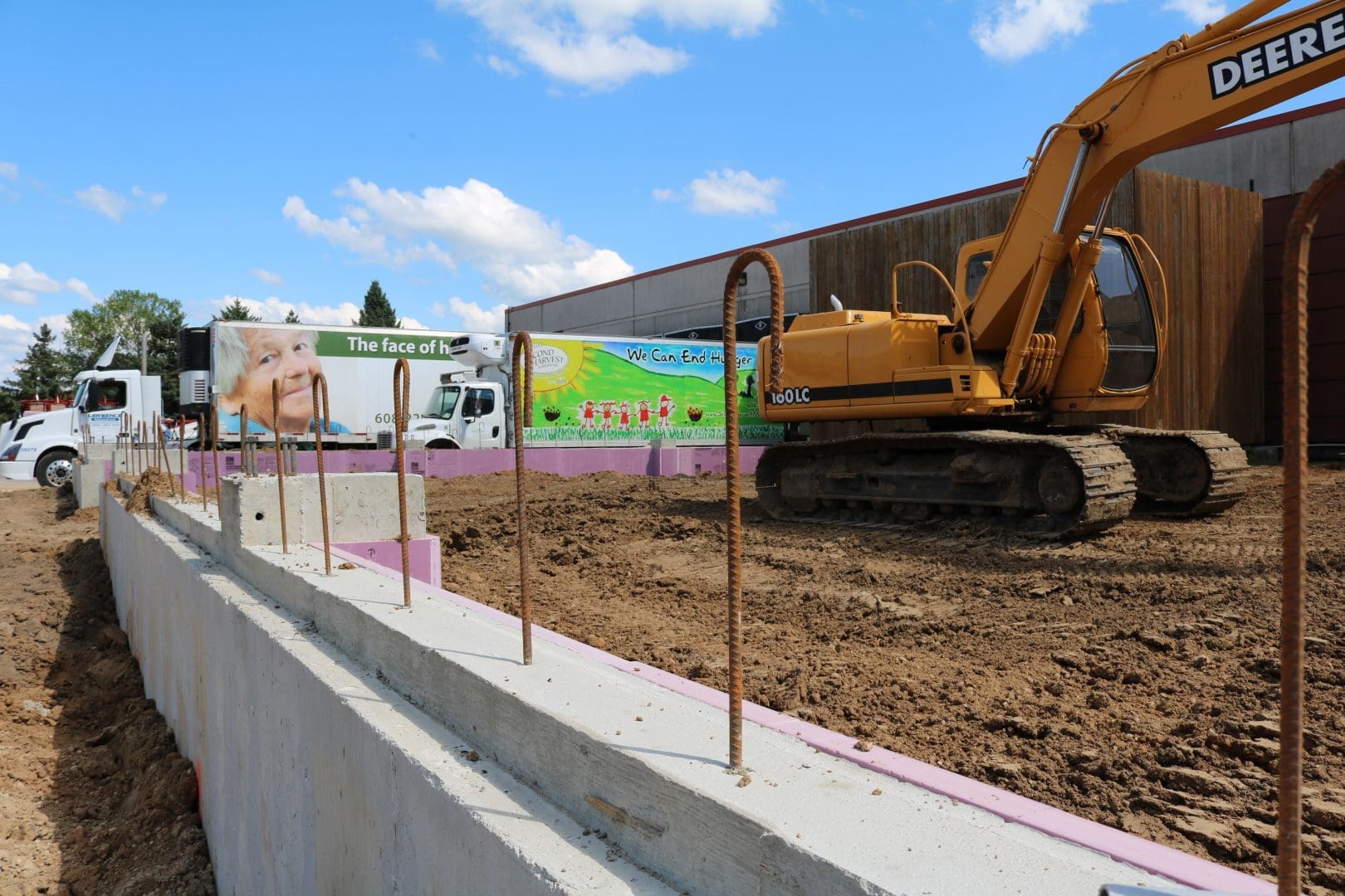 Construction at a warehouse building site with an excavator