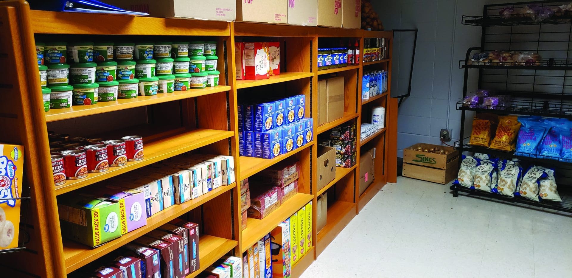 Food pantry shelves stocked with canned and packaged foods