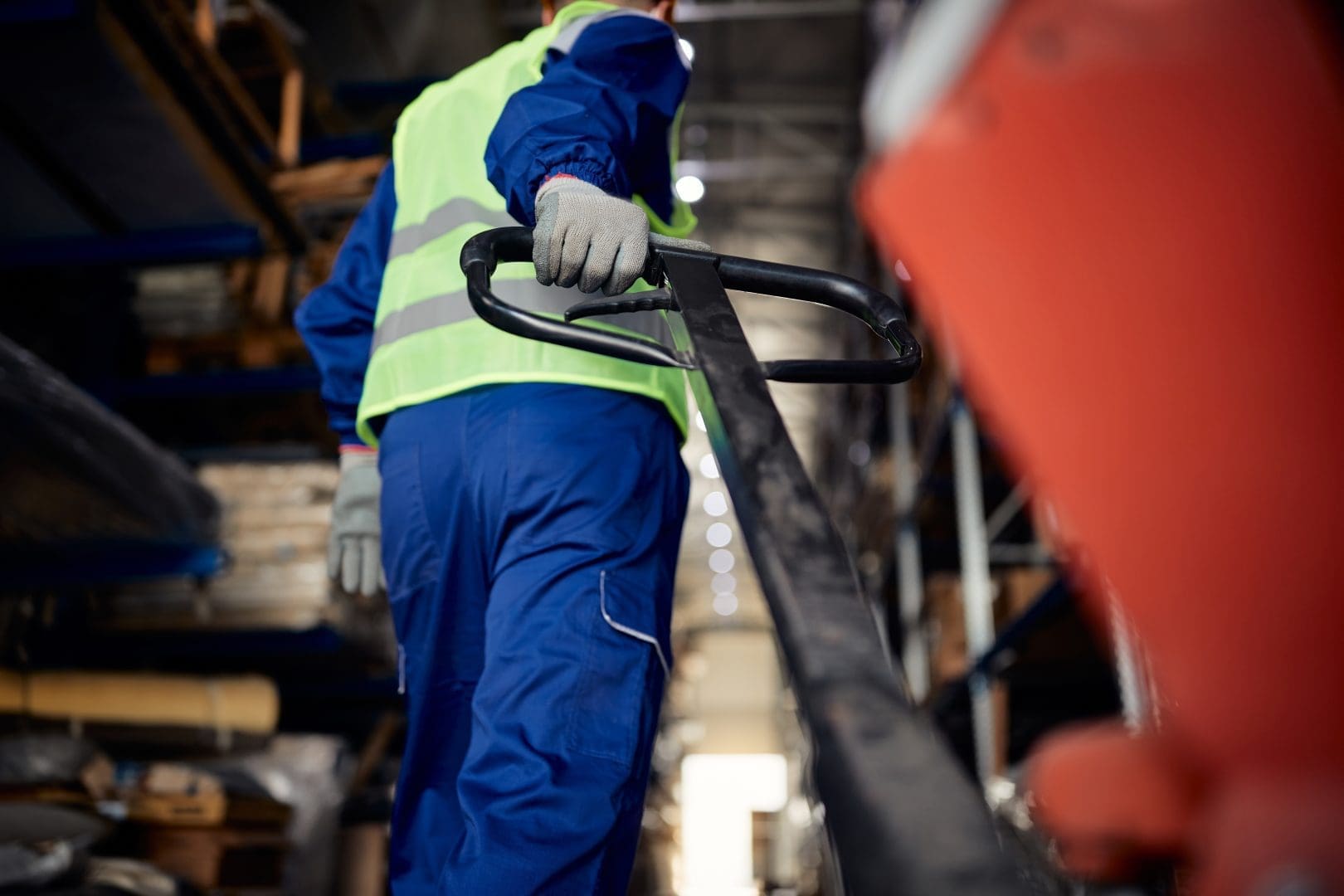 Warehouse worker operating forklift
