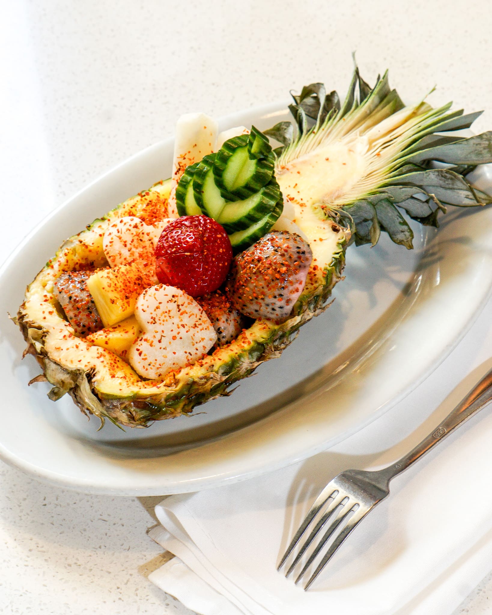 Pineapple filled with fruit.