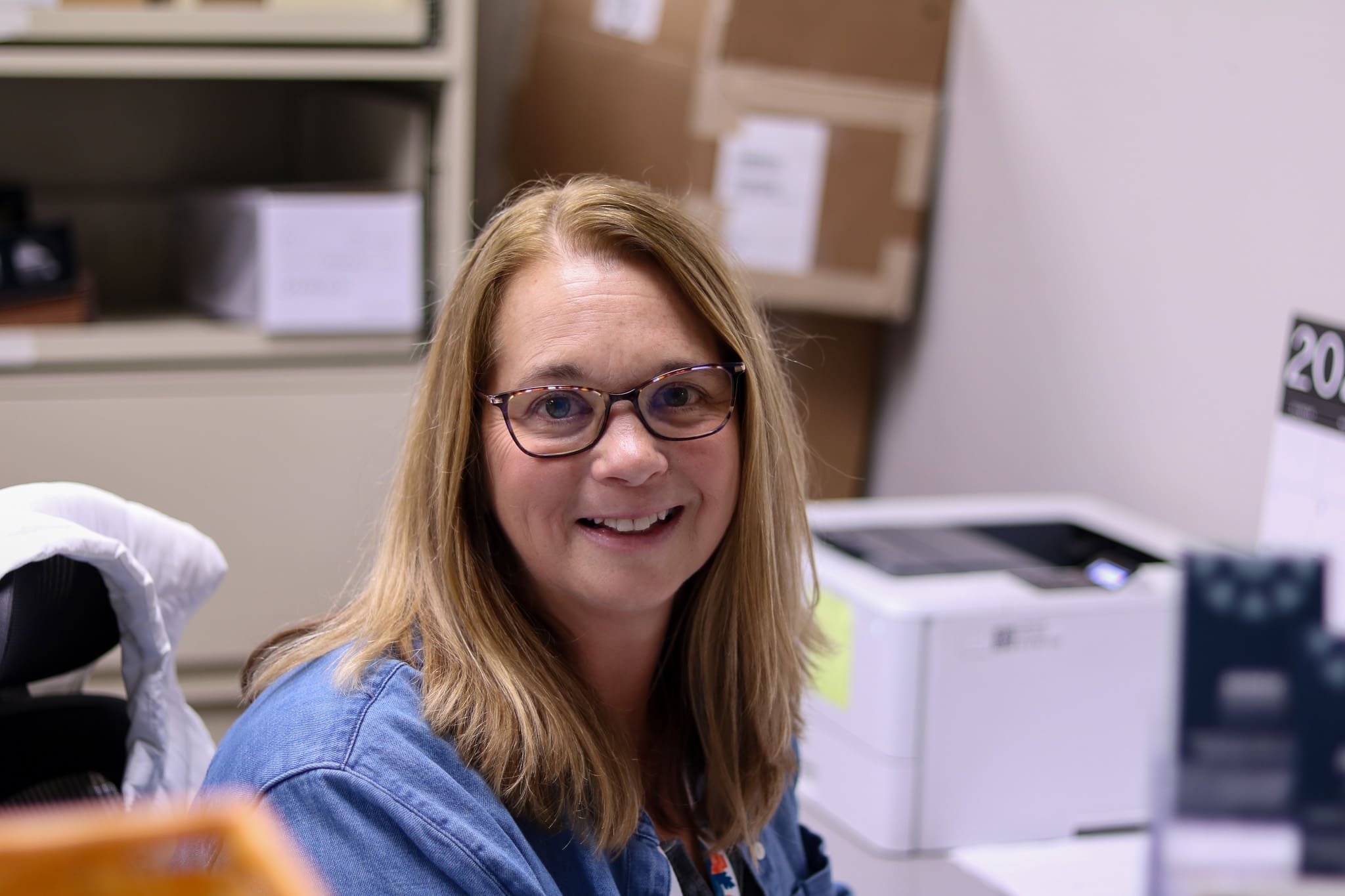 Second harvest volunteer team member smiling in the warehouse office